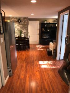 a living room with a wooden floor and a dining room at Cozy and modern 3 bedroom in central location! in Victoria +6 photos