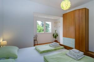 Postel nebo postele na pokoji v ubytování KON-TIKI Apartments