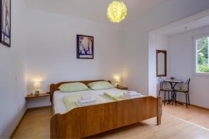 Postel nebo postele na pokoji v ubytování KON-TIKI Apartments