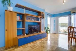 a living room with a large entertainment center with a tv at KON-TIKI Apartments in Mali Lošinj