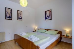 Postel nebo postele na pokoji v ubytování KON-TIKI Apartments