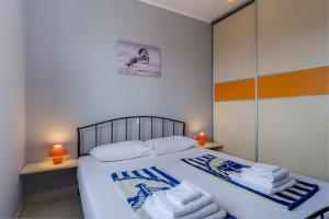 Postel nebo postele na pokoji v ubytování KON-TIKI Apartments