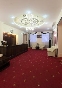 a large room with a red carpet and a stage at Apart Hotel Cherepovets in Cherepovets