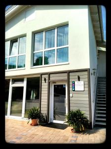 a building with a door and some plants in front of it at Haus VITALIS - Guesthouse Burgenland in Sigless