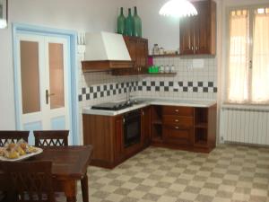 eine Küche mit Holzschränken und einem Tisch mit einem Teller Essen in der Unterkunft In Vacanza a Gaeta - B&B L'Elica in Gaeta