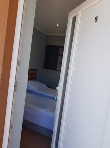 a door leading to a bedroom with a bed at Motel in Myszyniec