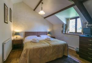 a bedroom with a bed and a window at The Barn B&B in Margam