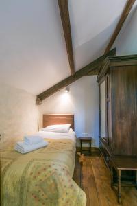 a bedroom with a bed and a dresser at The Barn B&B in Margam