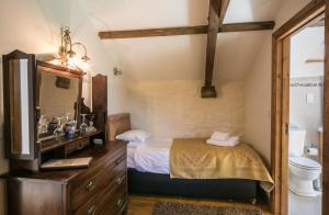 a bedroom with a bed and a dresser at The Barn B&B in Margam