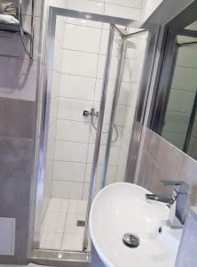 a bathroom with a sink and a shower at Motel in Myszyniec