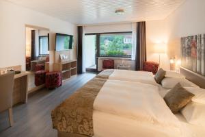 Postel nebo postele na pokoji v ubytování Best Western Plus Schwarzwald Residenz + 37 fotografií