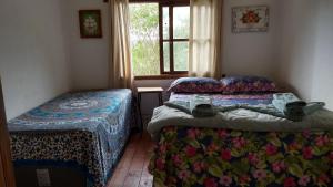 מיטה או מיטות בחדר ב-Aqua Montis Pousada