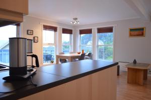 a kitchen with a counter top and a dining room at Apartment 2, Herand, Hardanger in Herand