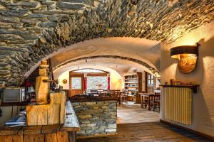 an archway in a building with a stone wall at Agriturismo il Fiocco in Cesana Torinese