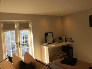 a room with a couch and a mirror and a window at number 26 in Conwy