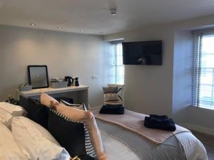a bedroom with a bed and a flat screen tv at number 26 in Conwy
