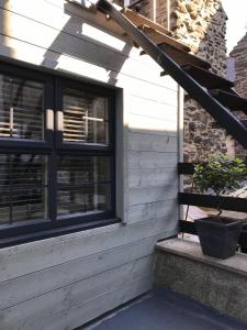 a porch of a house with a potted plant at number 26 in Conwy