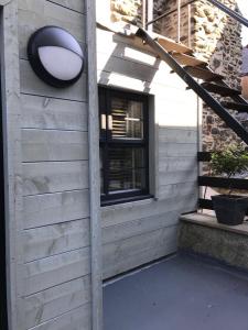 a building with a door and a window and a staircase at number 26 in Conwy