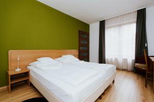 Ένα ή περισσότερα κρεβάτια σε δωμάτιο στο Hotel Mátrix
