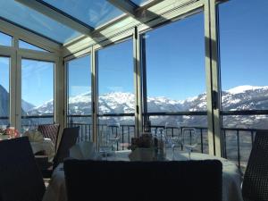 a dining room with a table and views of mountains at Hotel Restaurant Kulm in Triesenberg