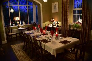 a dining room with a table with red candles at The Rectory B&B in Cloghan