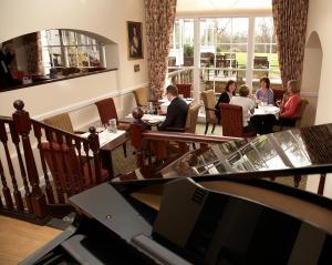 people sitting around a dining room table at West Lodge Park in Barnet