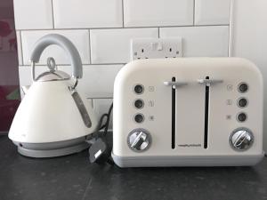 a toaster and a tea kettle on a counter at Phoenix House Apartments in Walsall