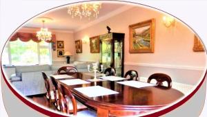 a dining room with a table and chairs and a mirror at Leabrook House in Castlemaine +60 photos