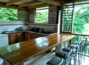 a kitchen with a wooden table and some chairs at Cabana El Caney in Sapzurro
