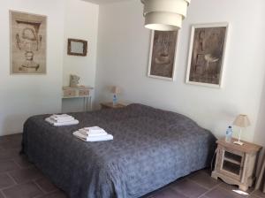 Un dormitorio con una cama con dos toallas encima. en La bergerie de Castellan, en Verquières
