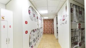 a hallway in a hospital with posters on the walls at City Hostel in Sochi