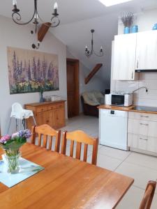 a kitchen and dining room with a table and chairs at Lawendowe Siedlisko in Zator