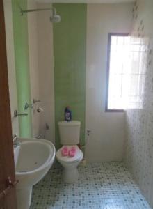 a bathroom with a toilet and a tub and a sink at Maison Casero Home Stay in Cochin