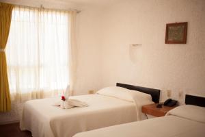 Postel nebo postele na pokoji v ubytování Hotel Carrillos Cancun