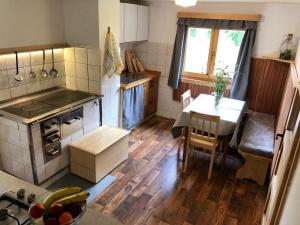 a kitchen with a table and a dining room at Holiday House Franc in Srednja Vas v Bohinju