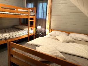a bedroom with two bunk beds in a house at Holiday House Franc in Srednja Vas v Bohinju