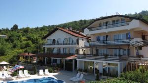 a large building with a swimming pool in front of it at Villa Angelos in Ohrid