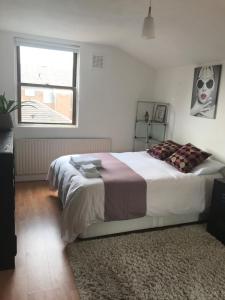 a bedroom with a large bed and a window at Amazing Room in London