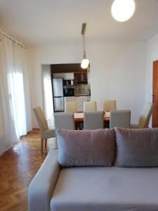 a living room with a couch and a table at Apartments Mira in Bibinje