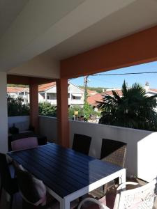 a balcony with a blue table and chairs at Apartments Mira in Bibinje