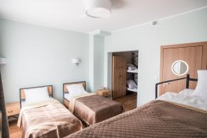 Łóżko lub łóżka w pokoju w obiekcie Dom Wypoczynkowy Simurg