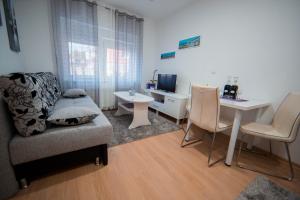 a living room with a couch and a table at Apartman Lucija in Livno