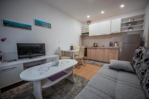 a living room with a couch and a table at Apartman Lucija in Livno