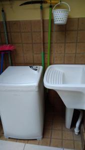 a bathroom with a toilet and a sink at casa Barra Velha - SC in Barra Velha +22 photos