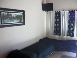 a small bedroom with a bed and a window at Costa Luna Federacion in Federación
