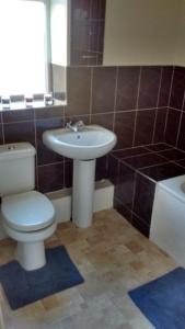a bathroom with a toilet and a sink and a tub at Derwent Street Apartment 1 - 3 Bed Self Catering Apartment - Self Contained - 1 Double & 2 Single Rooms in Workington