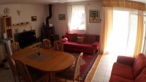 a living room with a table and a red couch at Apartments Iva und Franka in Omiš