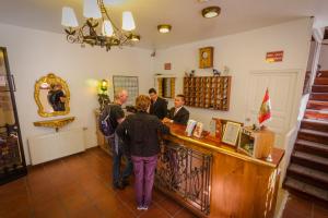 a group of people standing at a counter in a shop at Hotel Rumi Punku in Cusco