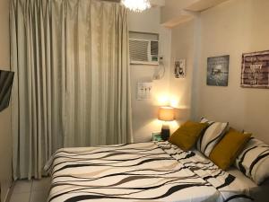 a bedroom with a bed and a window at Camella Northpoint Condo Studio in Davao City