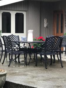 a patio table with four chairs and a lamp on it at McIvor Lodge in Invercargill